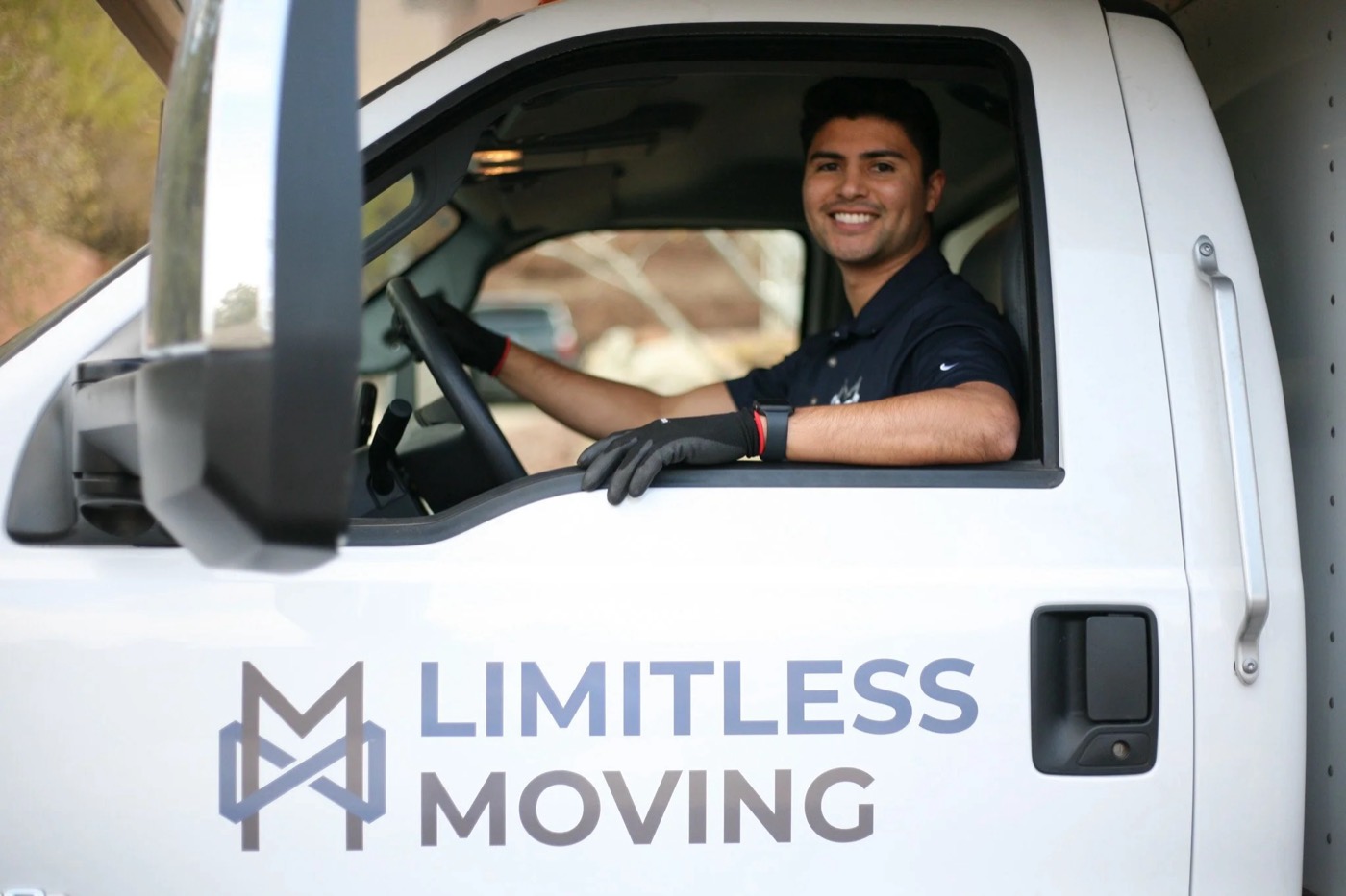 Limitless Moving driver smiling from the cab of the company truck