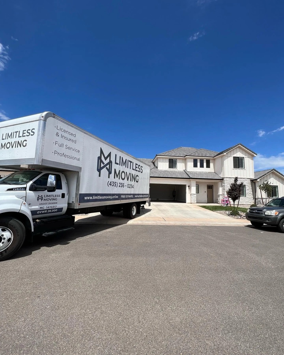 Limitless Moving truck in front of a newly built two-story home